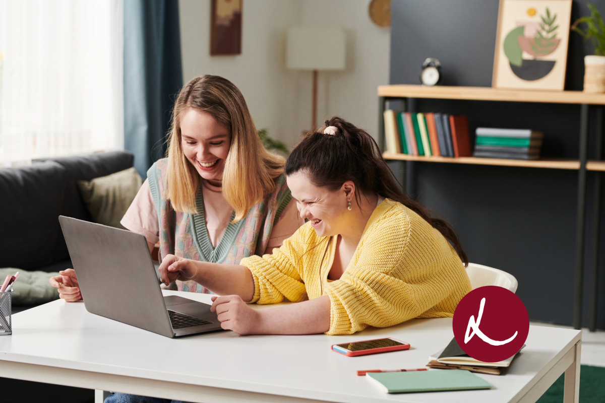 Two woman looking at laptop
