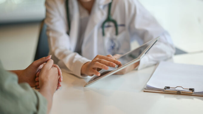 Doctor reviewing chart with patient