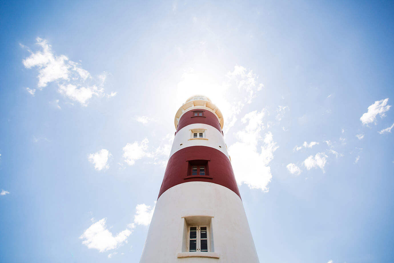 M&A: Sell-Side Image Lighthouse on blue sky background on Mauritius