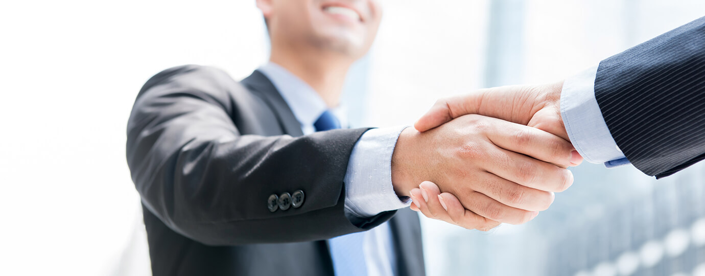 Management Advisory Imaeg Smiling businessman making handshake with his partner outdoors in the city