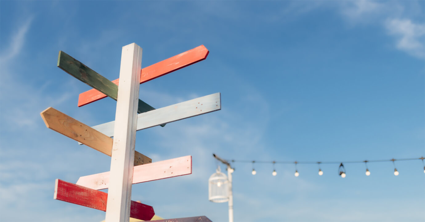 Signpost in front of blue sky