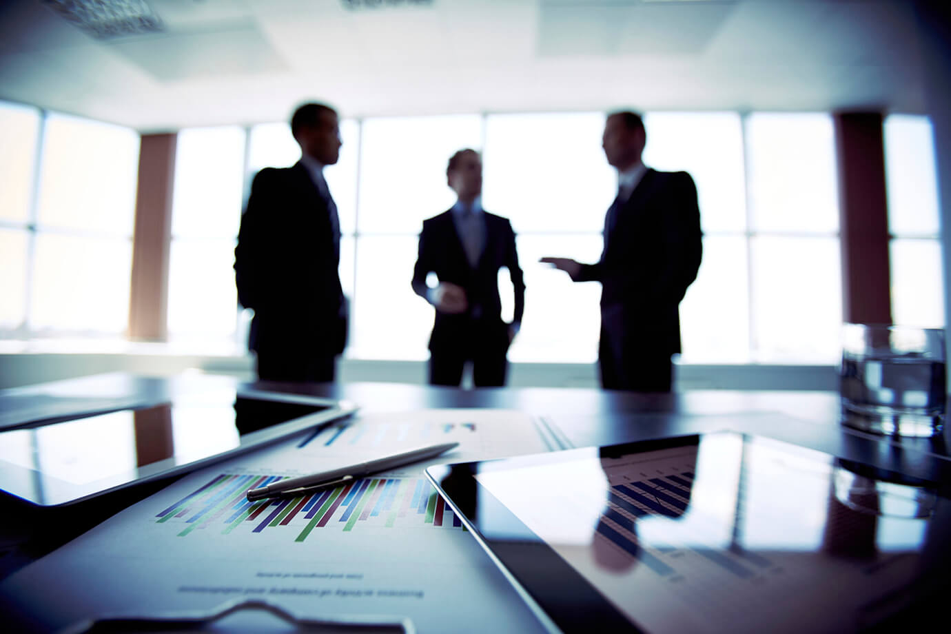 Group of business men standing in conference room