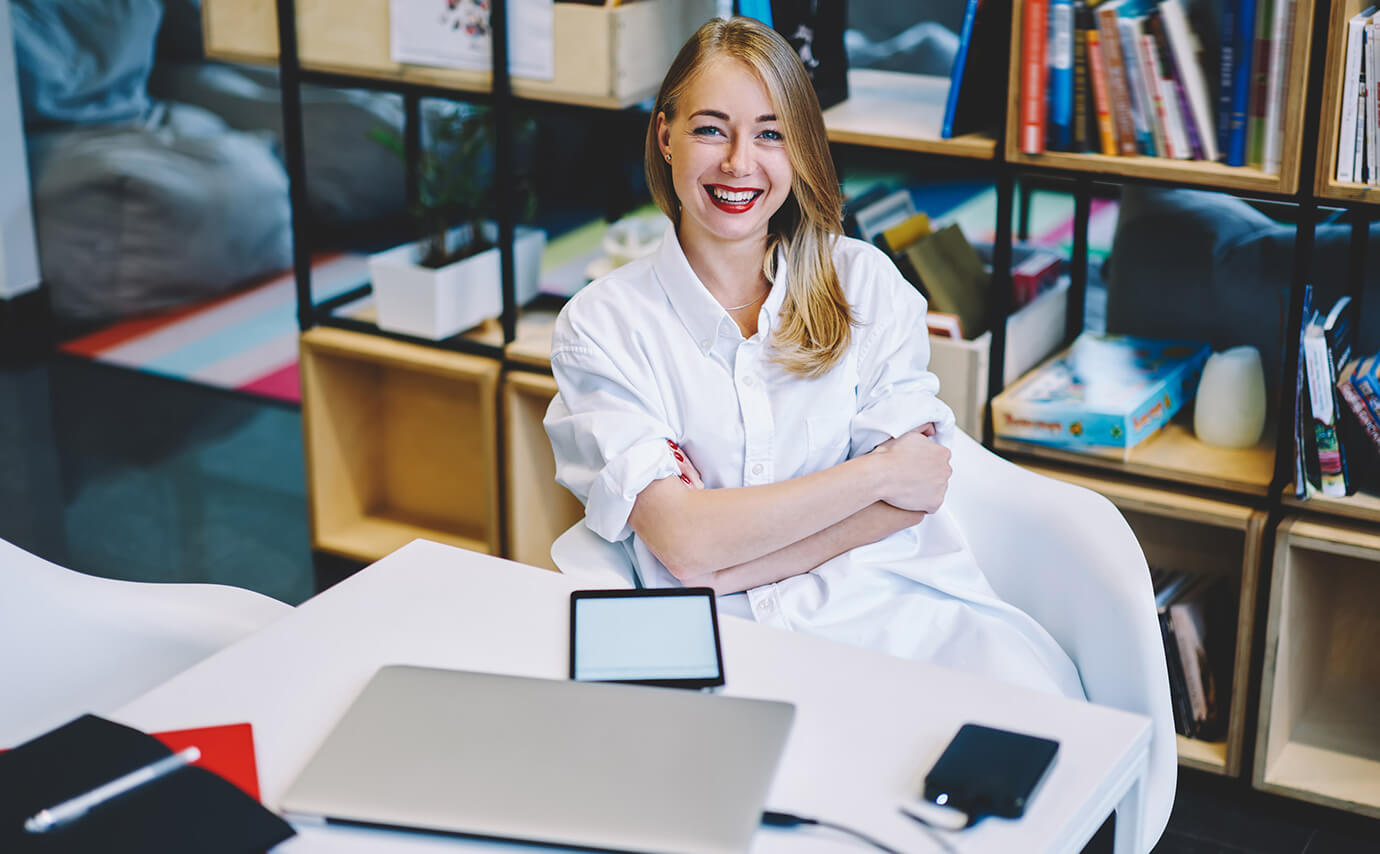 Female student in a classroom smiling at the camera