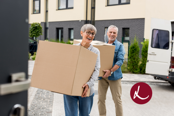 Elderly Couple Carrying moving boxes