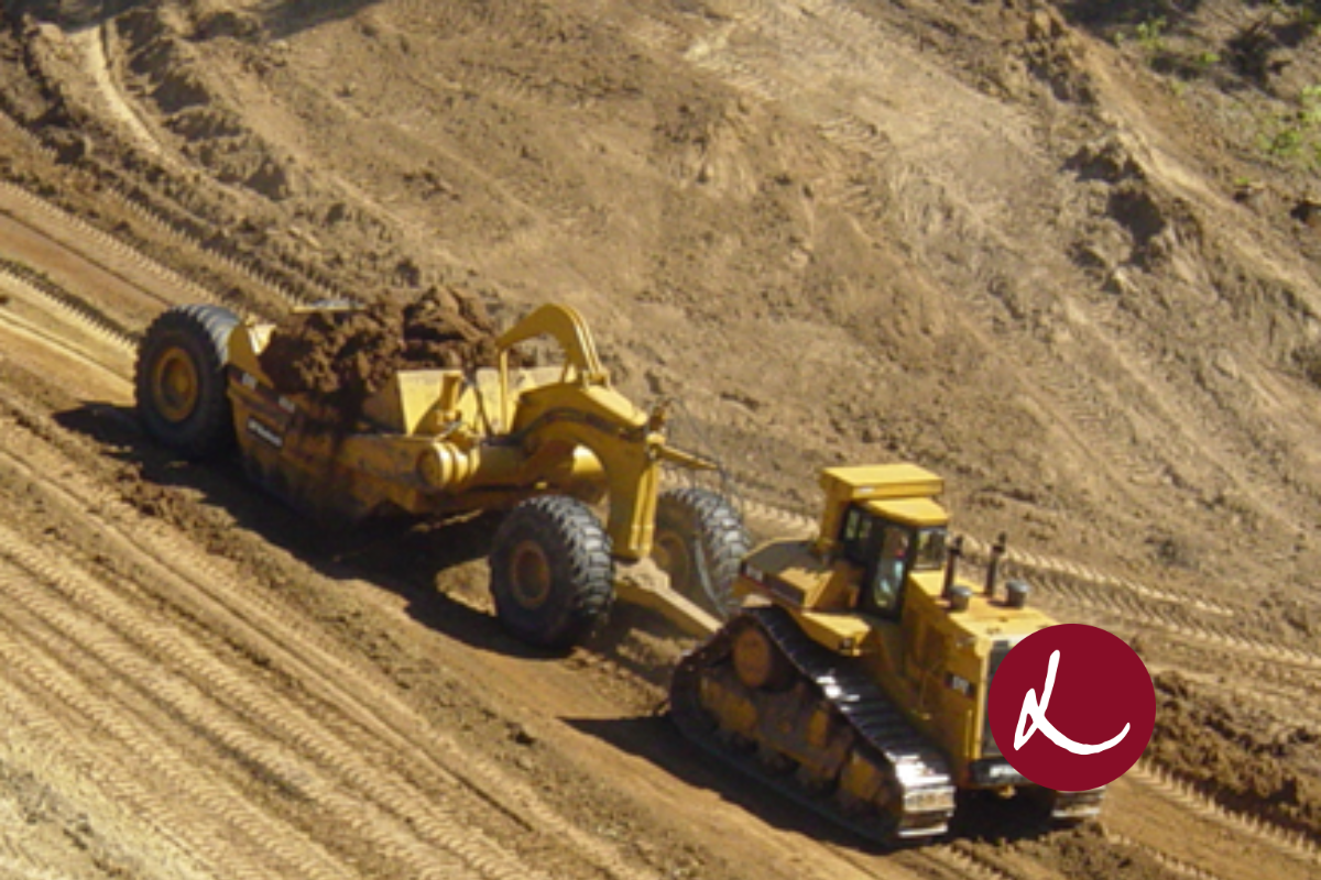 Construction Trucks driving across dirt